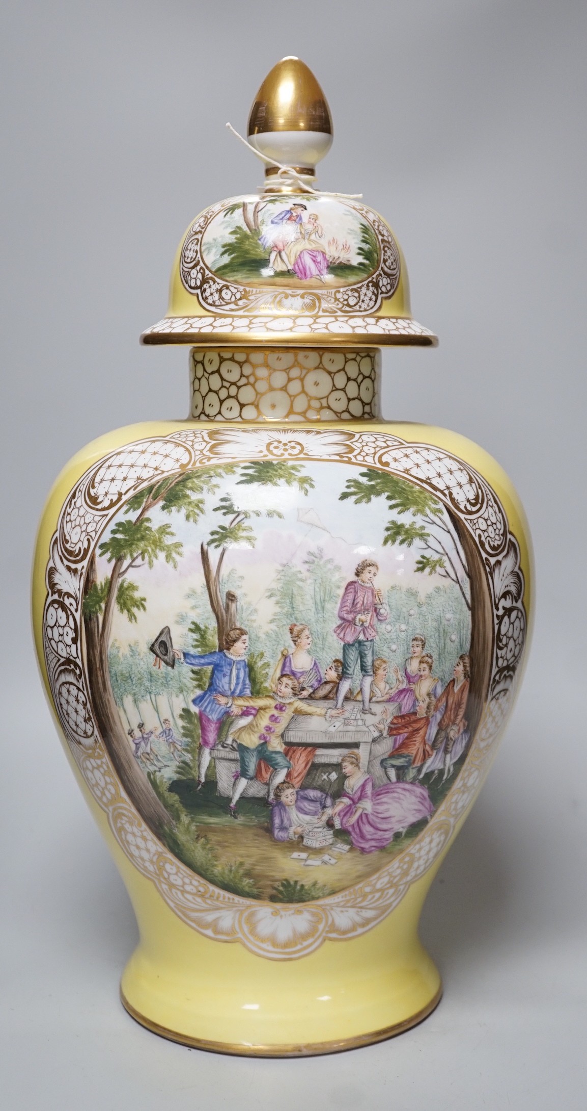 A large Helena Wolfsohn, Dresden vase and cover, from 1880, with a painted figural fishing cartouche one side and leisure activities the other, 52cms high